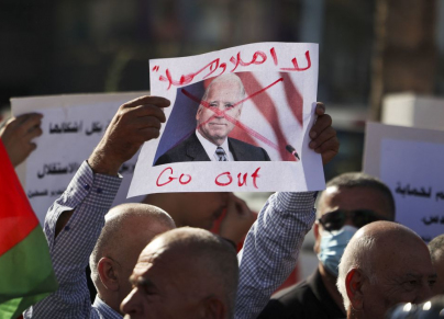 لافتة رُفعت في رام الله، تنديدًا بزيارة الرئيس الأمريكي جو بايدن (ABBAS MOMANI/Getty)
