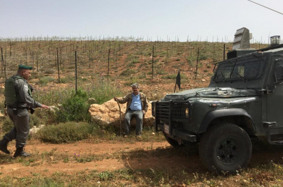 المزارع نضال ربيع بالقرب من أرضه في قرية ترمسعيا وجيش الاحتلال متواجدًا في المكان