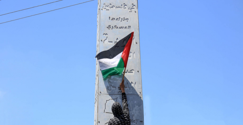 شاب يرفع علم فلسطيني خلال تظاهرة بغزة دعمًا للقدس