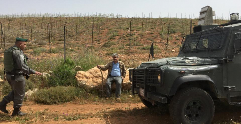 المزارع نضال ربيع بالقرب من أرضه في قرية ترمسعيا وجيش الاحتلال متواجدًا في المكان
